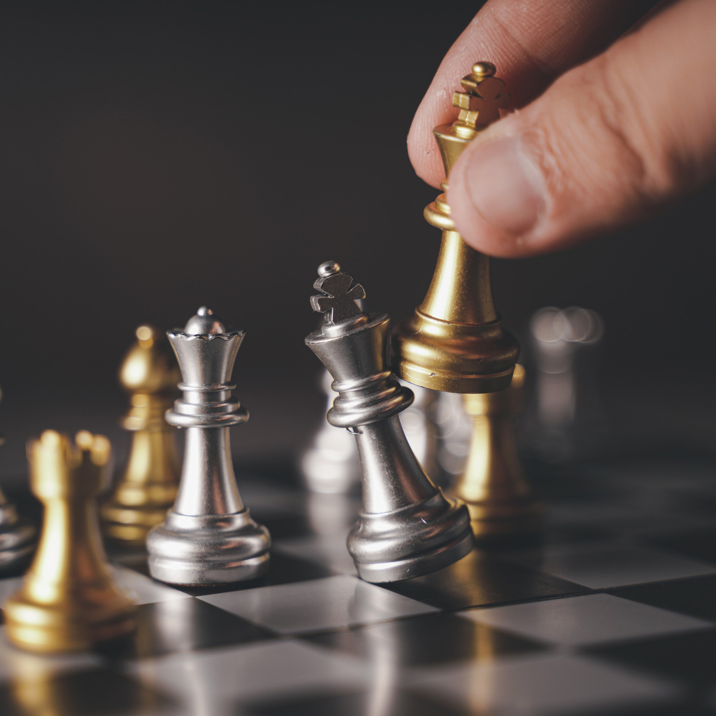 Hand moving a chess piece